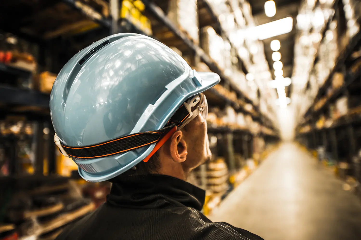 Modern Warehouse Worker in Safety Helmet